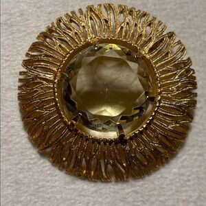 Gold Tone Filigree Brooch with light green glass center